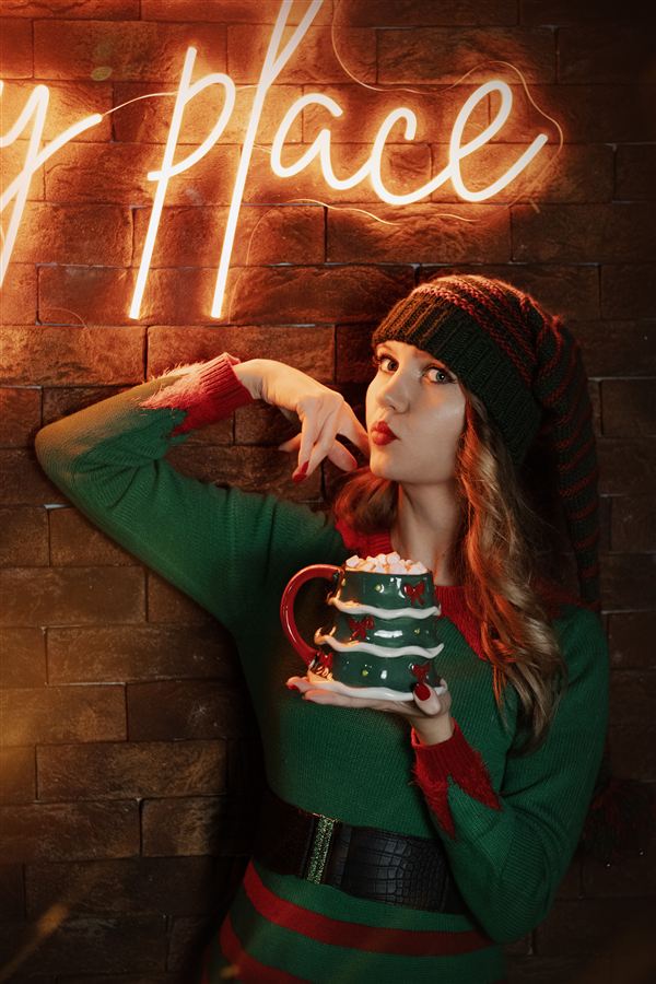 Festive shot with a neon sign and a Christmas mug