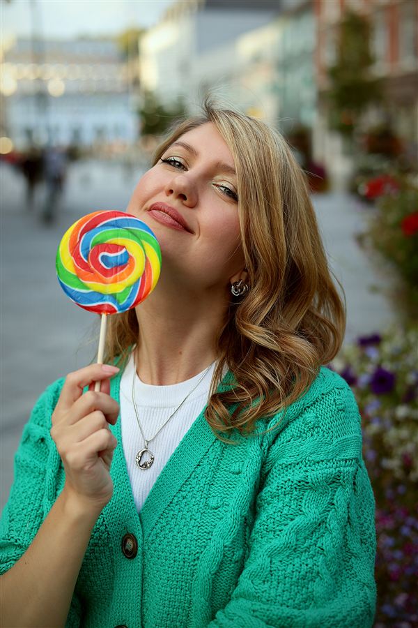 Street lifestyle portrait with a rainbow lollipop