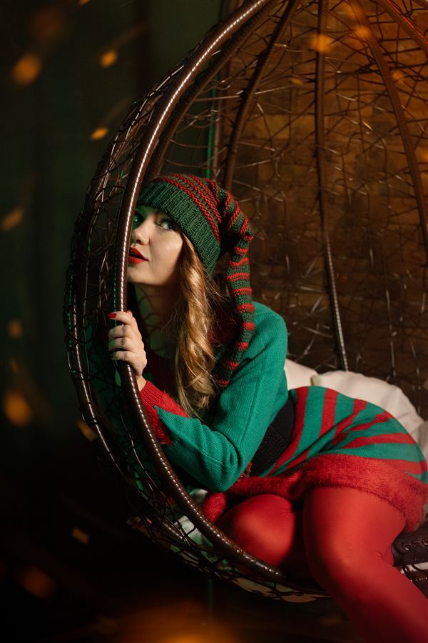 Festive elf-style shot in a hanging chair with warm lights