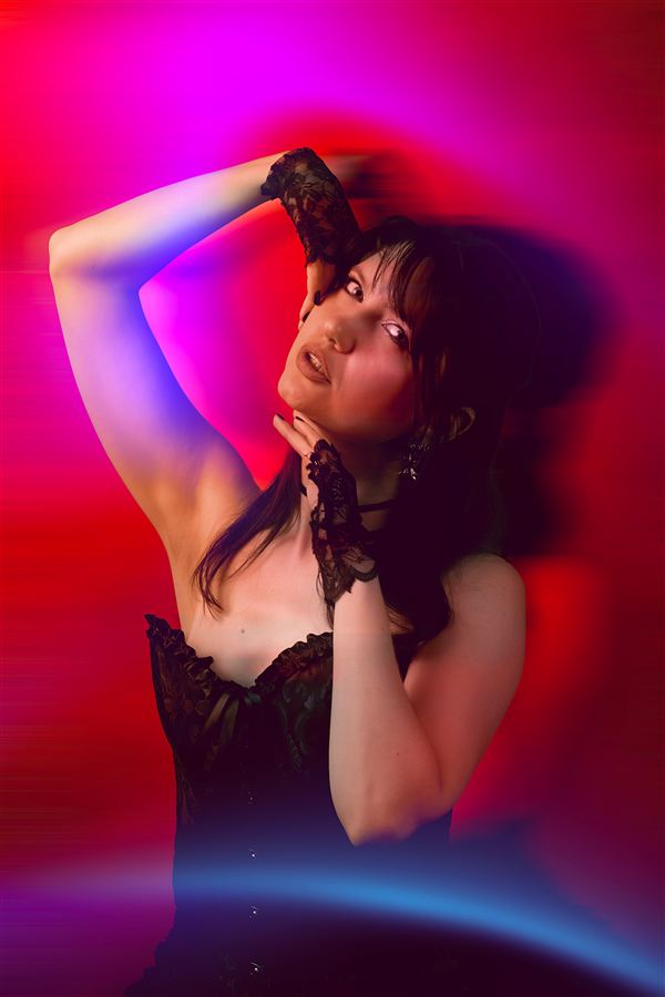 Editorial shot in vivid neon light with lace gloves