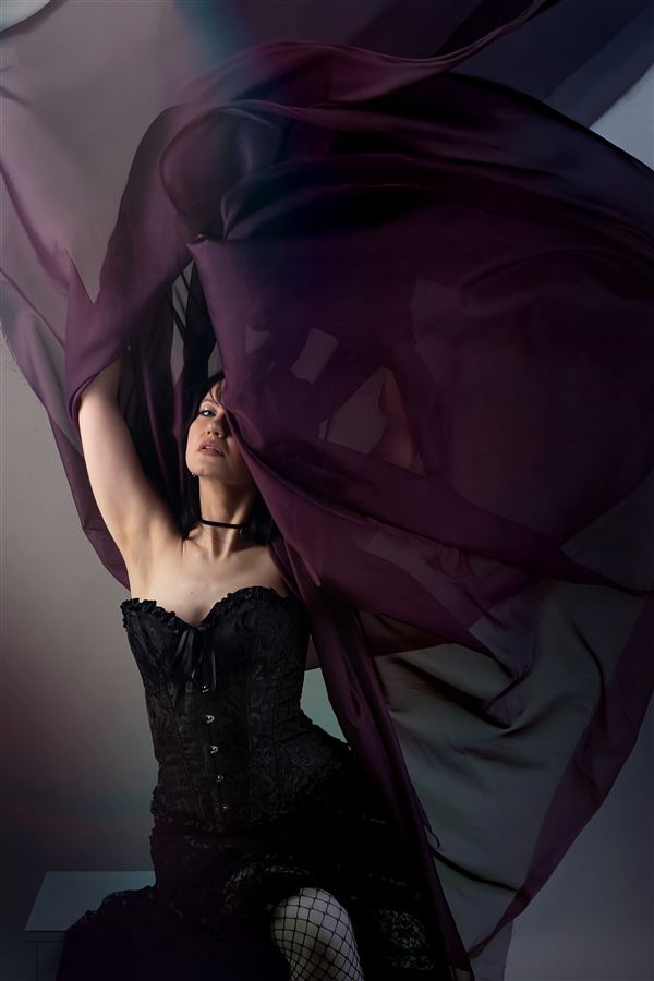 Editorial with flowing dark fabric and a corset